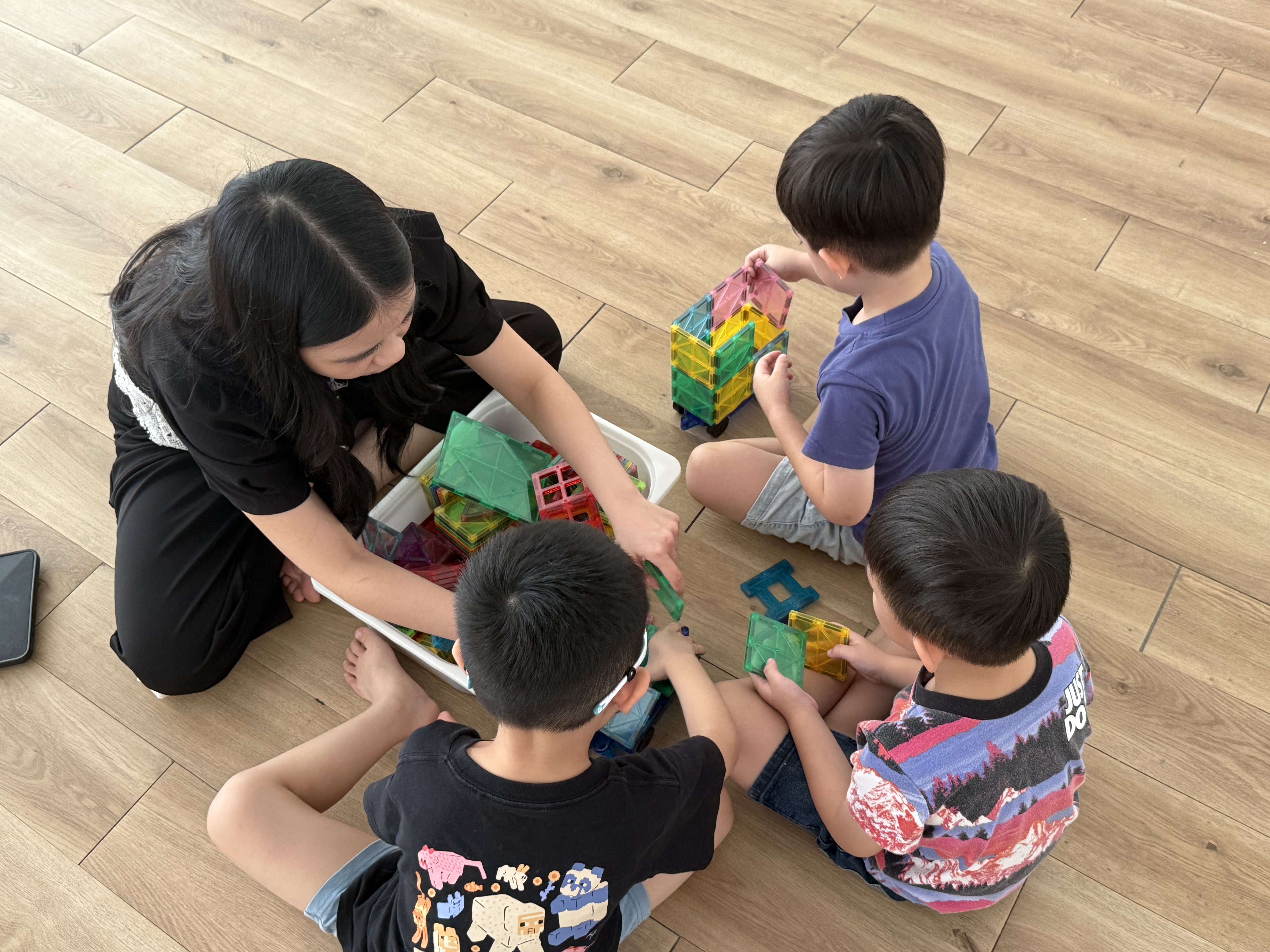 Children enjoying an activity together at Growing Minds