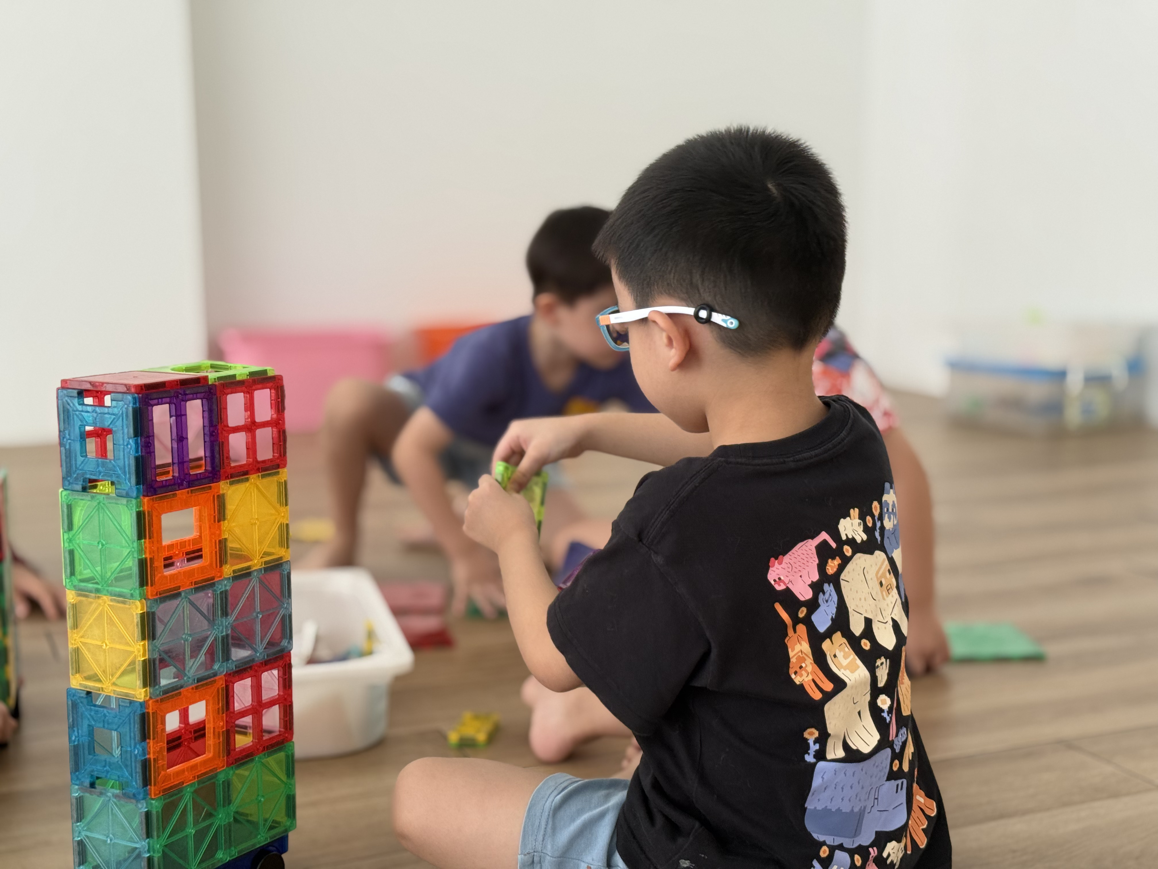 Children enjoying an activity together at Growing Minds